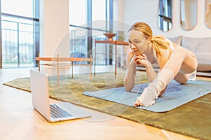 caucasian woman attending online yoga lesson