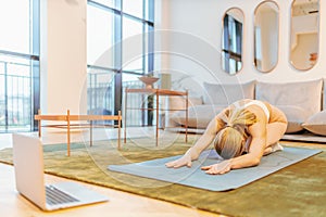 caucasian woman attending online yoga lesson