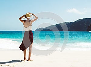 Caucasian woman at the beach enjoying nature at tropical resort.