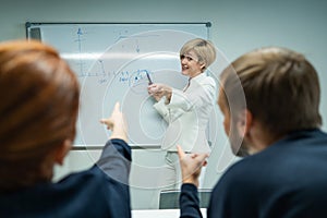 Caucasian woman blonde leads a presentation for colleagues.