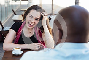 Caucasian woman with brunette hair flirting with african american man