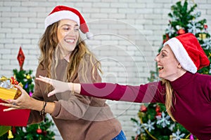 Caucasian woman celebrating  festival traditional with Christmas tree and gift box with friend