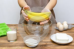 Caucasian woman chef in apron preparing ingredients for making cottage cheese muffins cupcakes casserole at home kitchen, cuisine