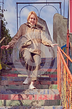Caucasian woman descends down the rainbow stairs