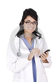 Caucasian woman doctor wearing a lab coat and entering data into a PDA