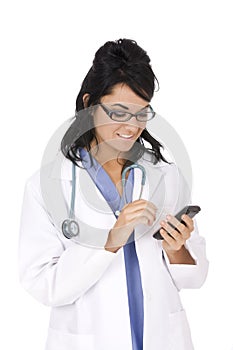 Caucasian woman doctor wearing a lab coat and entering data into a PDA