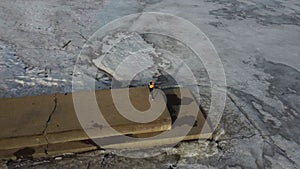 Caucasian woman doing yoga on the pier of the frozen lake.