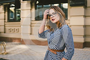 Caucasian woman in dress travels in old European town. Trip and rent, book hotel for weekend, rent apartments in city