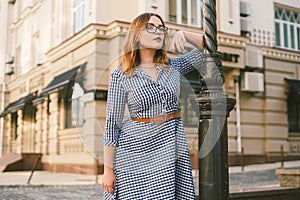 Caucasian woman in dress travels in old European town. Trip and rent, book hotel for weekend, rent apartments in city center.