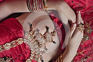 Caucasian woman dressed in Indian bridal Sari along with specific jewelry