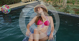 Caucasian woman enjoying the pool during a sunny day