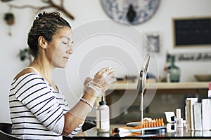 Caucasian woman enjoying self made beauty farm and hair style concept at home - hair dye activity during lockdown quarantine with