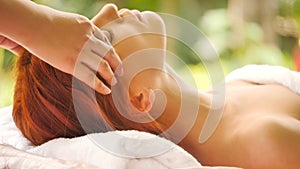 Caucasian woman getting head massage at spa