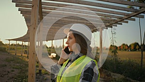 Caucasian woman girl ecological engineer female architect businesswoman inspector work uniform protective helmet talking