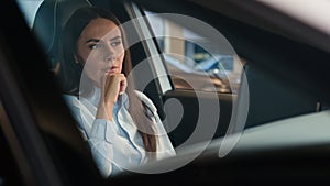 Caucasian woman girl lady driver businesswoman sitting inside car automobile at parking lot browsing smartphone stress