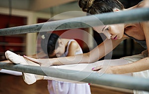 A Caucasian woman and girl practicing ballet