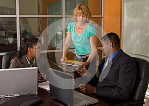 Caucasian Woman Hands Indian Businessman Folders