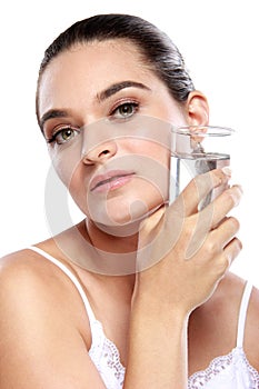 Caucasian woman holding a glass of water