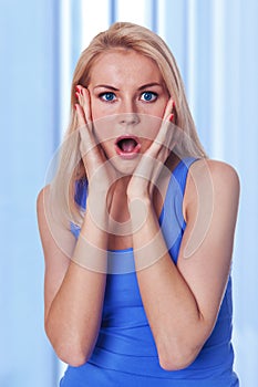 Caucasian woman holding her face in astonishment photo