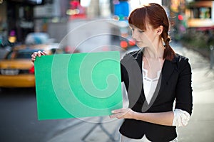 Caucasian woman holding message board