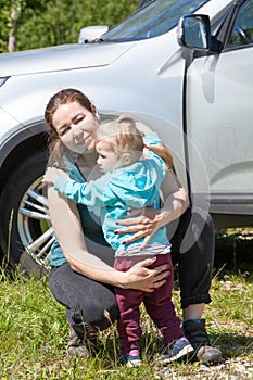 Caucasian woman hugging her little daughter