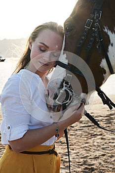 Caucasian woman hugging horse slow motion. Love and friendship concept.