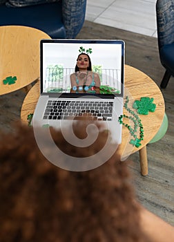 Caucasian woman on laptop screen blowing kiss making st patrick\'s day video call to friend