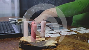 caucasian woman laying out cards on a wooden table