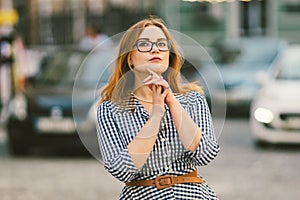 Caucasian woman and light bulb with bokeh background. street style fashion. European trip, old city, summer vacation. happy
