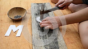 Caucasian woman makes handmade board with nails