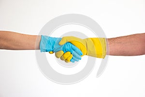 Caucasian woman and man hands and arms in blue and yellow latex gloves shacking hands isolate on white