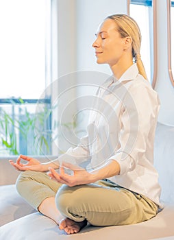 caucasian woman meditating at home