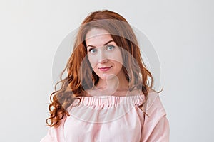 Caucasian woman model with ginger hair posing indoors