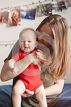 Caucasian woman mother holding cute adorable baby boy girl child