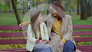 Caucasian woman mother mom talking with child girl kid daughter teen schoolgirl family talk friendly conversation