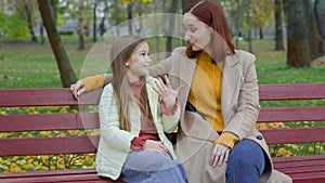 Caucasian woman mother mom talking with child girl kid daughter teen schoolgirl family talk friendly conversation