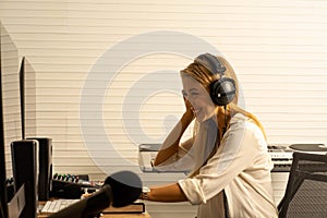 Caucasian woman musician singer in recoding studio with microphone. Performance arts concept