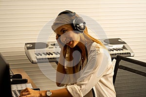 Caucasian woman musician singer in recoding studio with microphone. Performance arts concept