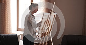 Caucasian woman painting on canvas