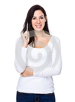 Caucasian woman with pen point up