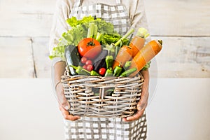 Caucasian woman people with bucket full of coloured and mixed fresh healthy food like fruit and vegetables