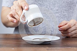 A caucasian woman is performing fortune reading kahve fali using leftover coffee grounds photo