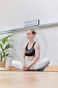 Caucasian woman performing meditations and breaths of yoga or pilates photo