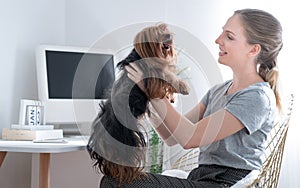 Caucasian woman playing with her dog at home.