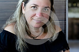 Caucasian woman portrait against gray colored wooden background