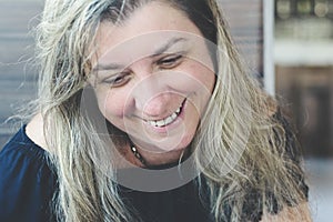 Caucasian woman portrait against gray colored wooden background