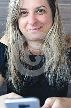 Caucasian woman portrait against gray colored wooden background