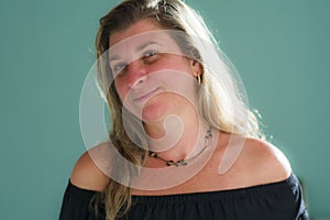 Caucasian woman portrait against light blue background