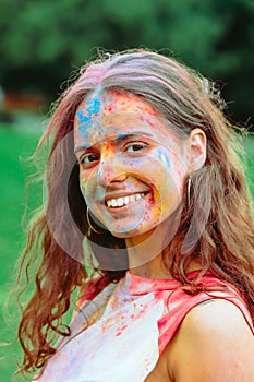 caucasian woman portrait in traditional indian holi festival paints