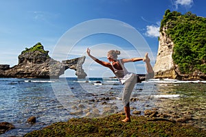 Caucasian woman practicing yoga at seashore